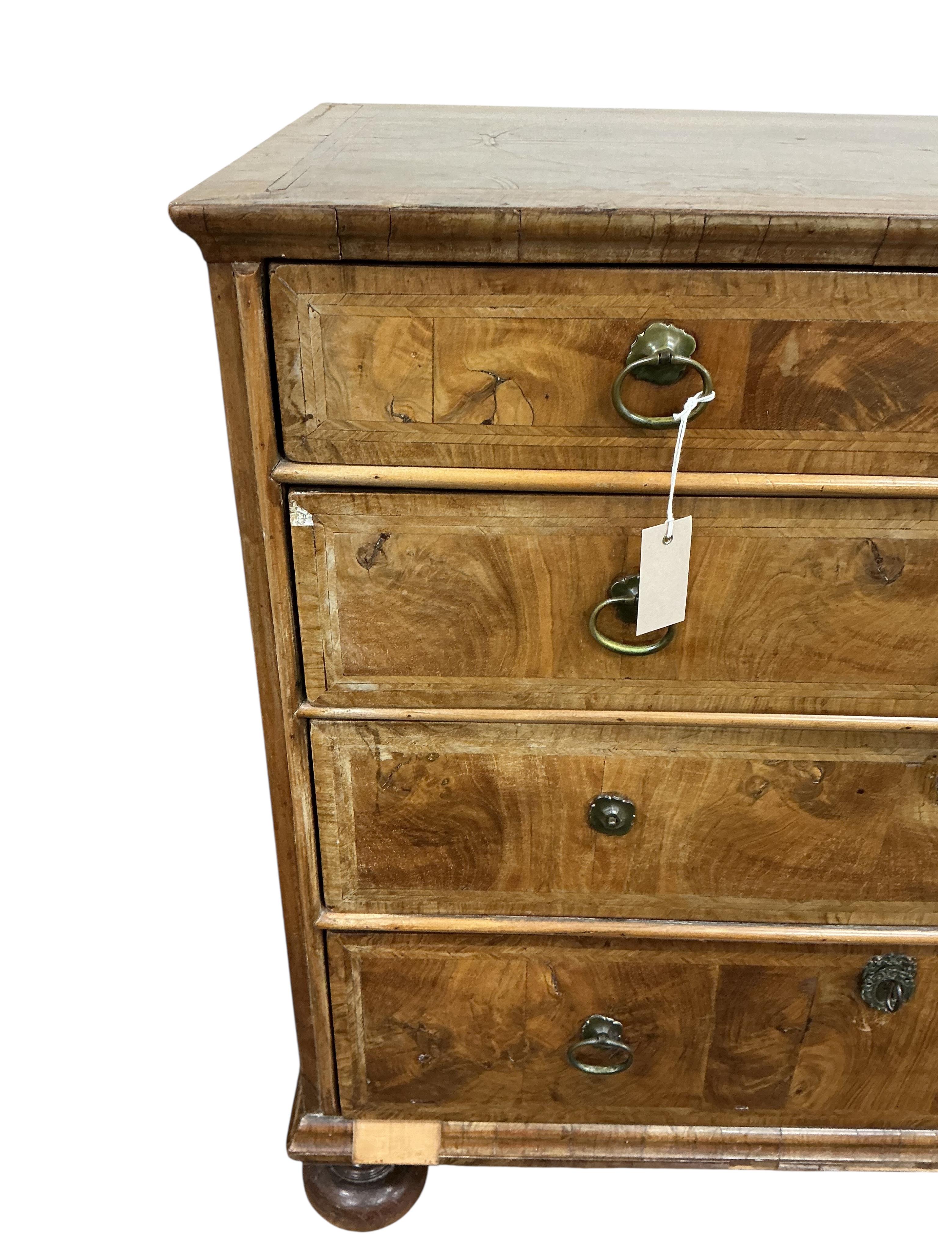 An early 18th century feather banded walnut chest, damaged, width 95cm, depth 54cm, height 91cm
